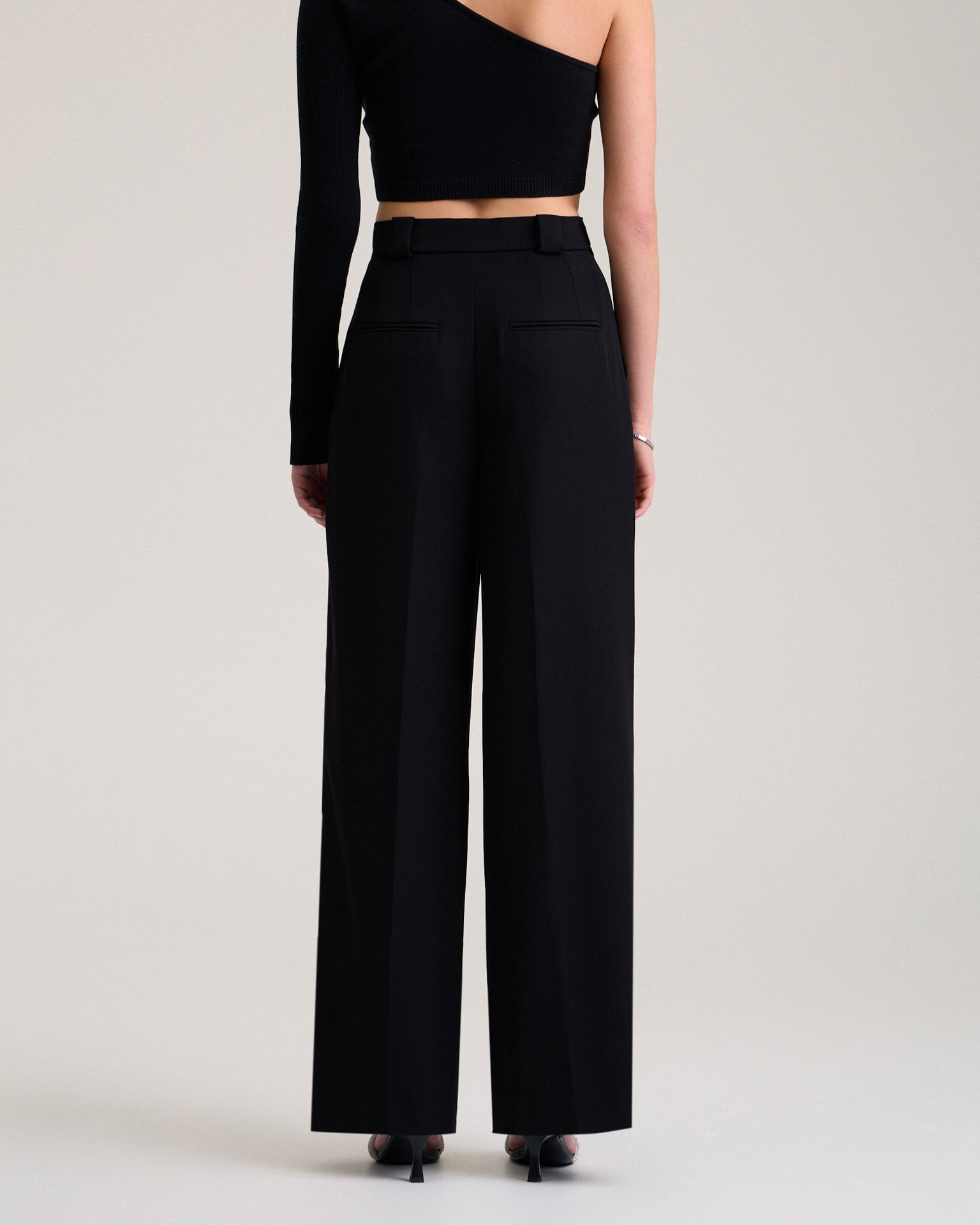 Trousers with decorative pocket in black