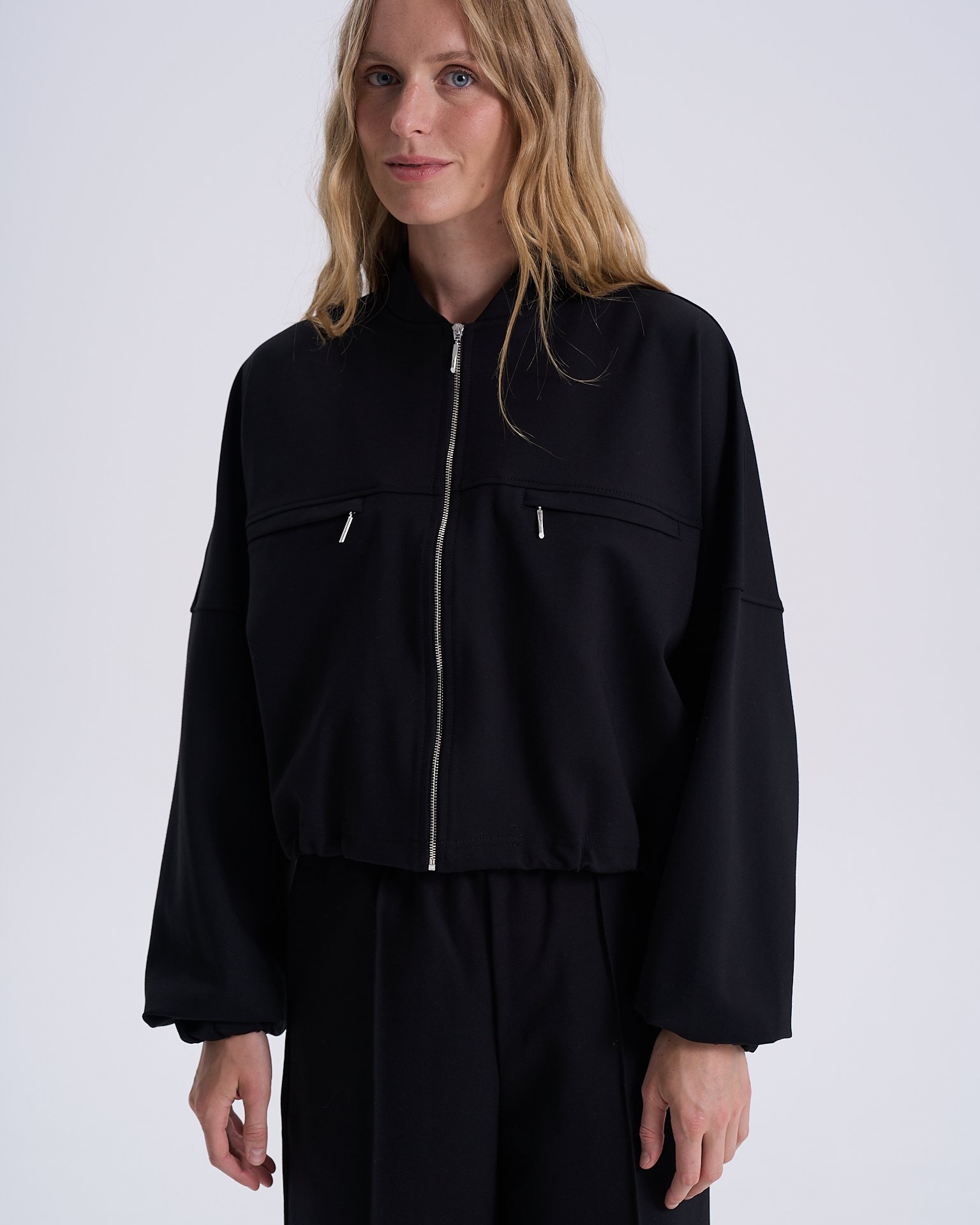 Black bomber jacket with adjustable ribbed hem